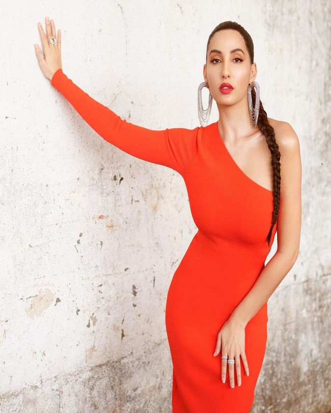 Nora Fatehi Alluring Poses in Orange Outfit